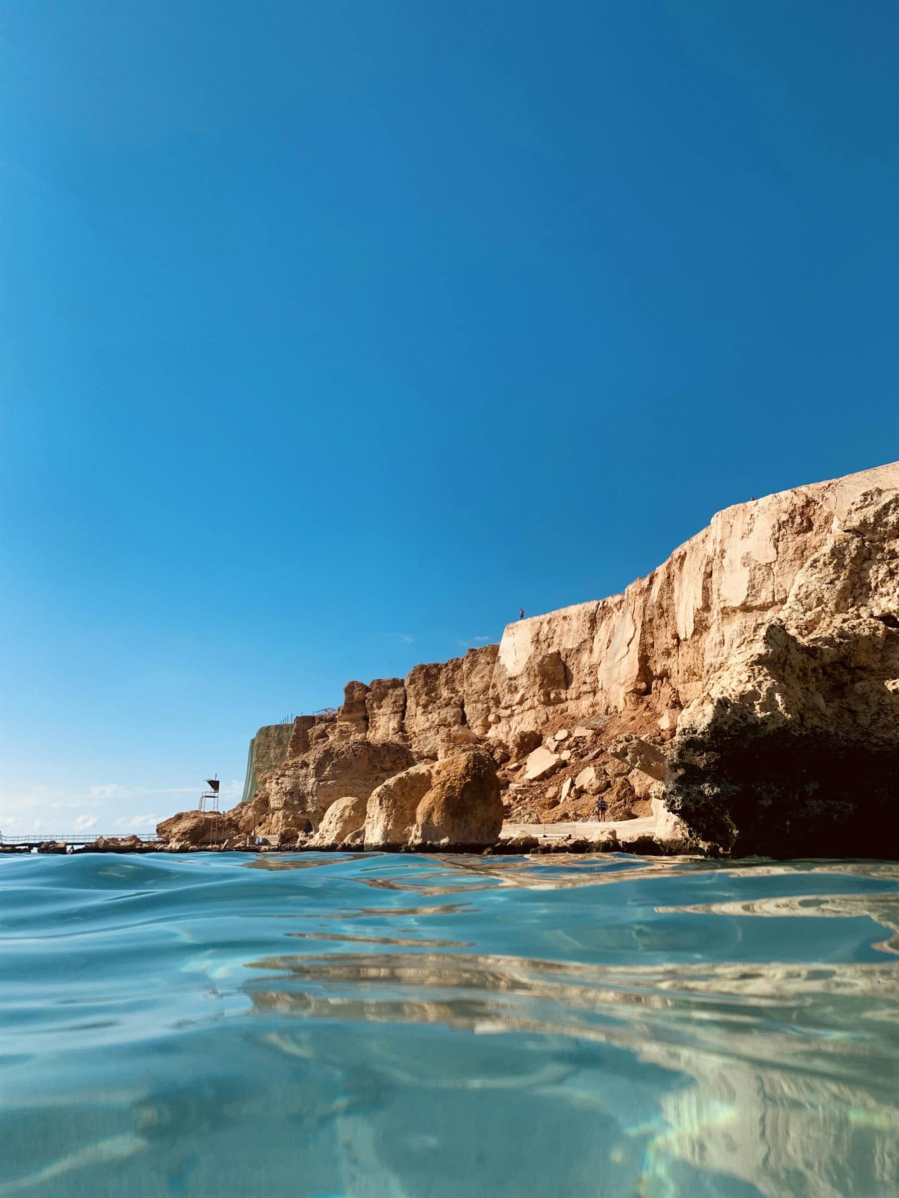 Clear turquoise water against the red cliffs of the Sinai coast