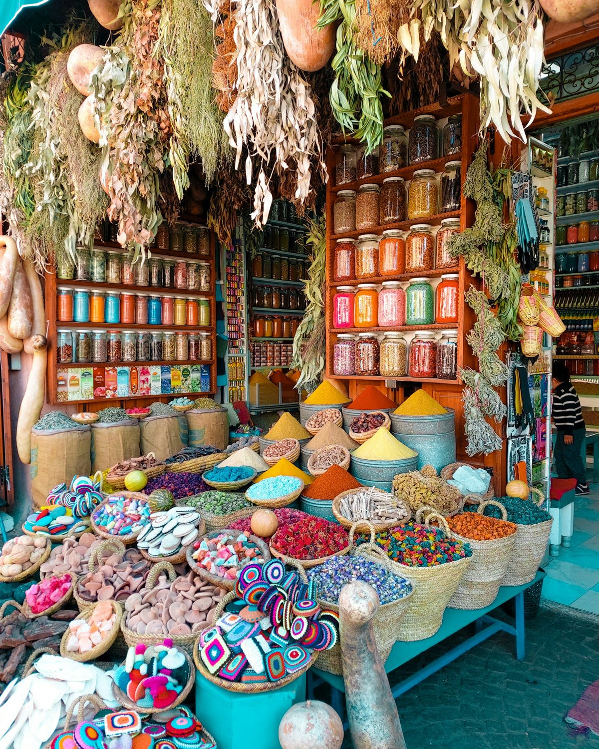 Baskets, spices and lanterns stacked high on a stall in the Marrakech souks