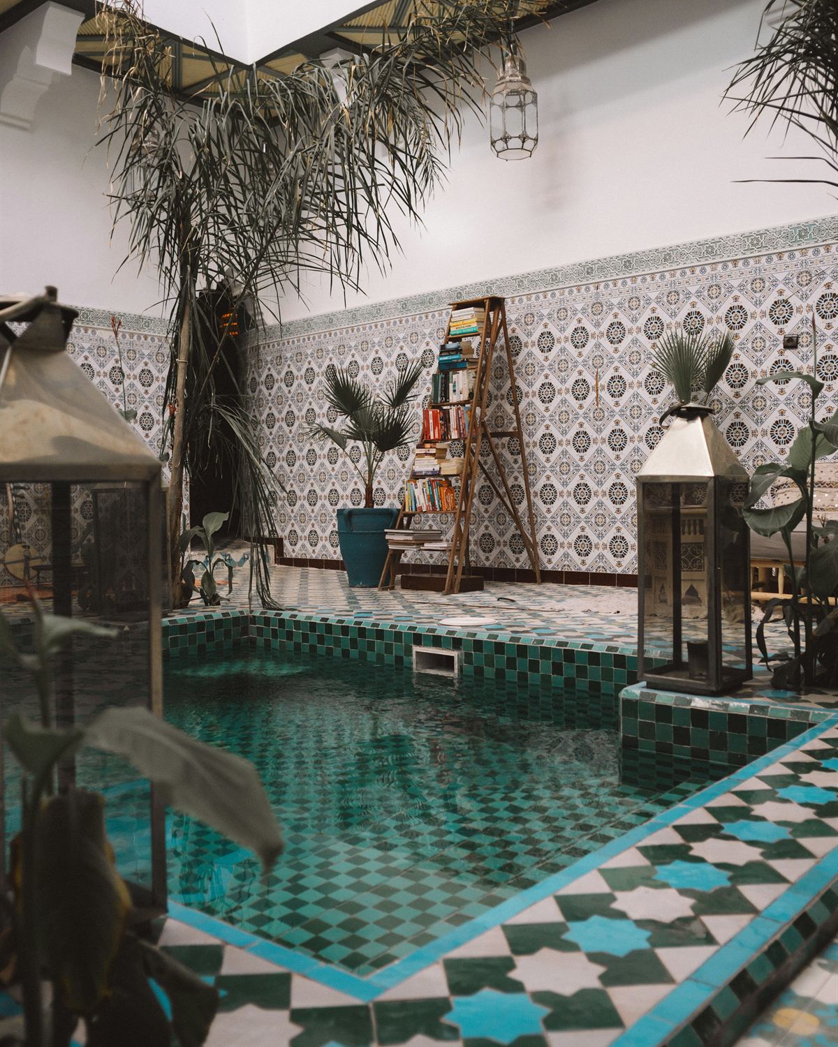 A green-tiled courtyard pool inside a Marrakech riad
